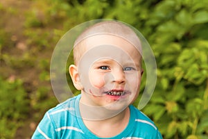 Portrait baby face dirty from blueberries