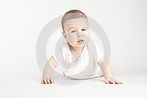 Portrait of a baby, face without emotions, look at the camera on a white background