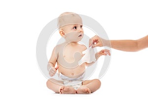 Portrait of a baby getting a diaper change: mom wiping baby`s bottom with baby wipe isolated on a white background. concept