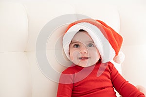 portrait baby girl 6 month in red bodysuit and Santa hat. minimalist.