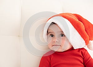 portrait baby girl 6 month in red bodysuit and Santa hat. minimalist.