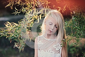 Portrait of a baby girl in the sunset light on the nature