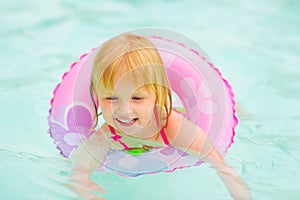 Portrait of baby girl with swimming in pool