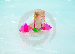 Portrait of baby girl swimming in sea