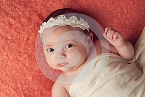 Portrait of a Baby Girl Wearing a Lace and Pearl Headband