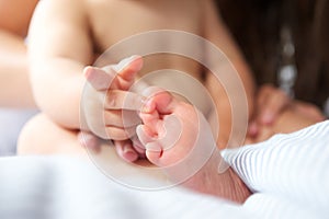 Portrait of a baby playing with toes