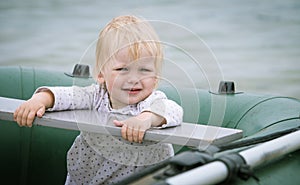 Portrait of a baby sitting in the old row boat