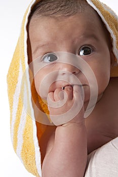 Portrait of a baby wrapped in a towel