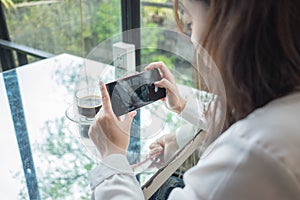 Portrait background woman using mobile phone take photo coffee c
