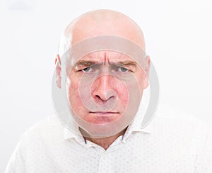 Portrait of bald adult mature man with emotions on white background