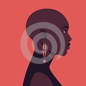 Portrait of a bald African woman in profile. Alopecia.