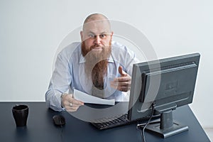 Portrait of a bald man at a desk looking at a report and cursing. The dissatisfied boss dismisses the subordinate.