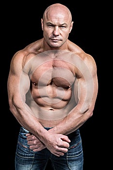 Portrait of bald man flexing muscles