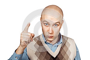 Portrait Bald serious man points and threatens with forefinger on an isolated white background