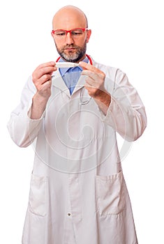 Portrait of bald slim doctor wearing white uniform, blue shirt, red stethoscope and glasses on white background. Caucasian in 40s