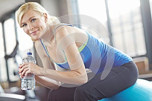 Portrait, ball or woman drinking water on break in exercise, workout or fitness training in gym. Relax, healthy girl or