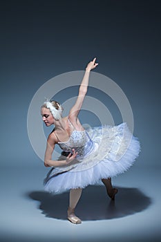 Portrait of the ballerina in ballet tatu on blue