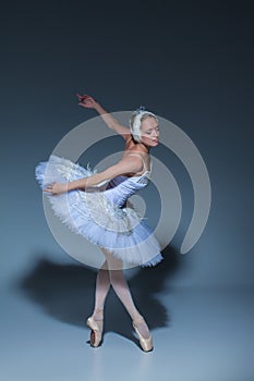 Portrait of the ballerina in ballet tatu on blue