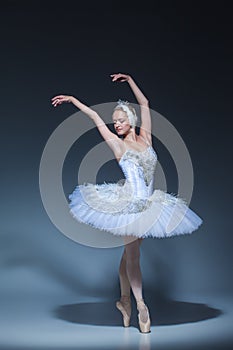 Portrait of the ballerina in ballet tatu on blue