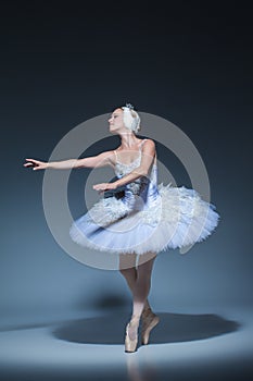 Portrait of the ballerina in ballet tatu on blue