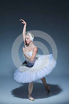 Portrait of the ballerina in ballet tatu on blue