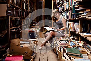 Portrait of ballerina girl in vintage book store wearing casual clothes