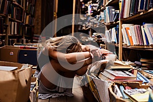 Portrait of ballerina girl in vintage book store wearing casual clothes