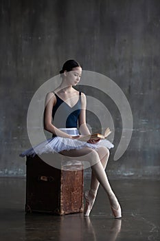 Portrait of a ballerina reading a book