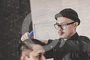 Portrait of barber hairstyle a costumer hair with hand and pomade in barbershop or salon