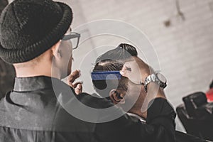 Portrait of barber hairstyle a costumer hair with hand and pomade in barbershop or salon