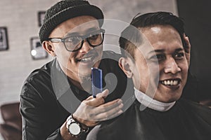Portrait of barber hairstyle a costumer hair with hand and pomade in barbershop or salon