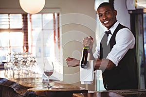 Portrait of bartender holding a wine bottle