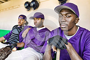 Portrait of baseball players sitting in dugout