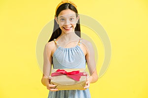 Portrait of a beaming girl receiving a gift