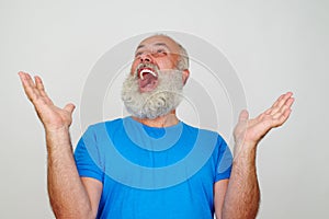 Portrait of bearded aged man who is happy and delighted