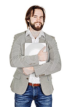 Portrait of bearded business man standing with laptop and looking at camera