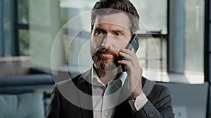 Portrait bearded Caucasian middle-aged adult business man talking phone at office negotiate virtual sales conversation