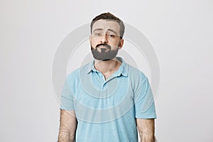 Portrait of a bearded guy looking unsatisfied and tired. Sometimes everyone have a bad day, so does this person. Man is