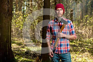Portrait of a bearded hipper forest ranger in a forest photo