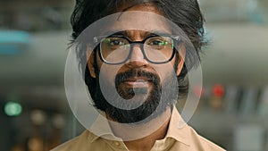 Portrait bearded Indian business man executive in office. Close up eastern male professional teacher businessman ethnic