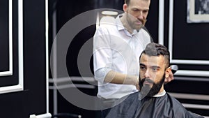 Portrait of a bearded man in a barbershop.