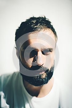 Portrait of a bearded man wearing white tshirt