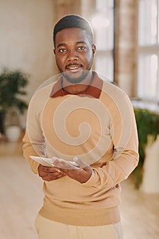 Portrait of bearded marketing specialist with tablet