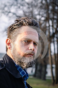 Portrait of a bearded middle-aged man against the background of a Christian monastery