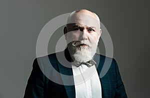 Portrait of a bearded middle-aged man over a gray studio background with copyspace. Serious Senior Man.