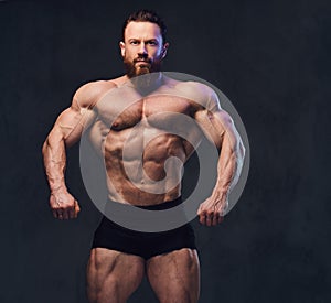 Portrait of bearded shirtless bodybuilder.