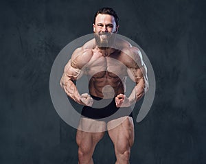 Portrait of bearded shirtless bodybuilder.