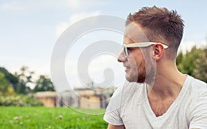 Portrait of bearded young man. Caucasian man smiling happy on sunny summer or spring day outside in park