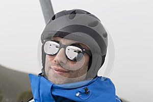 Portrait of bearded young man with sunglasses, rises to the top