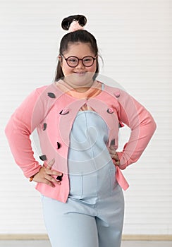 Portrait of beaufiful and cute teen Asian down syndrome girl posing as a model with fun and delight self-confidence